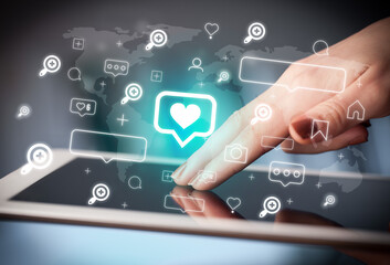 Close-up of a hand using tablet, social media concept