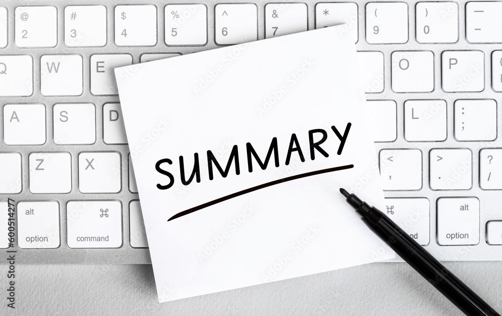 Poster white paper with text summary lying on the keyboard