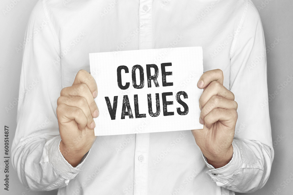 Poster man holding a paper card with text core values