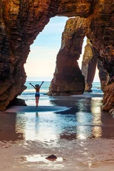 Foto op Plexiglas Donkerbruin Natural rock arches on Cathedrals beach,  tour tourism in Galicia, Woman, natural arch and beach- Spain