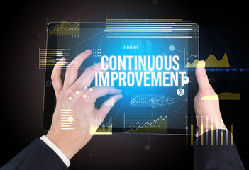 Close-up of hands holding tablet with business inscription