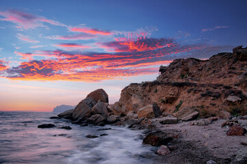 Landscape with sea shore, waves and stones on the rocks beach.