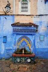 Traditional fountain in Chefchaouen, the blue city in Morocco old town.