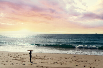 Hobby and vacation. Man holding a surfboard on beautiful ocean beach