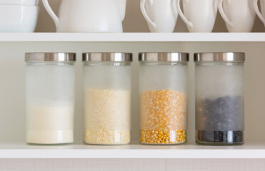 glass jars with grain on the shelf