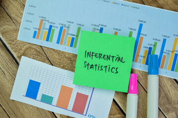Concept of Inferential Statistics write on sticky notes isolated on Wooden Table.