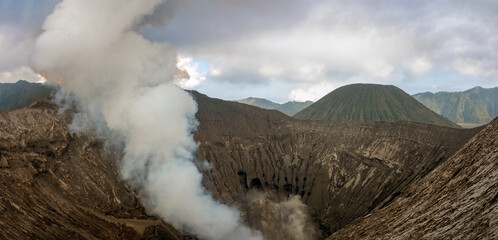 Hiking trail along the edge of Mount Bromo's crater with Mount Semeru, Mount Batok and the Sea of Sand (Segara Wedi) in the background, East, Java, Indonesia © Luis