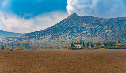 View of Mount Bromo (Gunung Bromo) volcano with the hindu temple Pura Luhur Poten at its base on...
