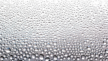 Water condensate drops on window glass.Drops of condensed steam on a transparent surface of glass or plastic.Window glass with condensation.Texture of water