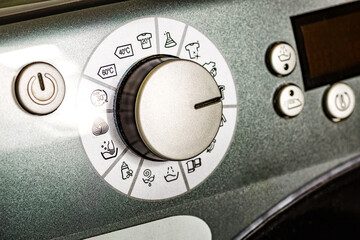 Washing machine.Modern washing machine front panel with display.Knob for selecting the modes of...