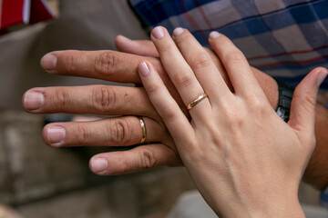 hands of a newly married caucasian couple showing their wedding rings. Love and commitment.