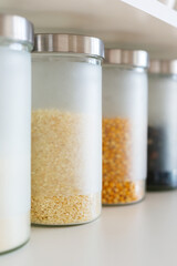 glass jars with grain on the shelf