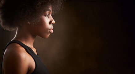 Young ethnic girl with afro hairstyle seen from the side