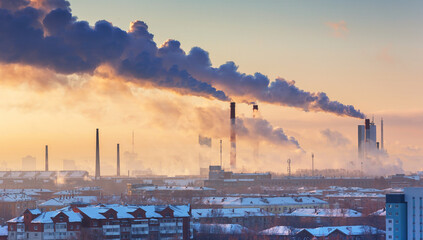 chimneys with smoke in the city at morning