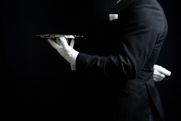 Portrait of Butler or Waiter in Dark Suit and White Gloves Holding Silver Serving Tray. Concept of Service Industry and Professional Hospitality.