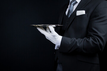 Portrait of Elegant Butler or Waiter in Dark Suit and White Gloves Holding Silver Service Tray. - obrazy, fototapety, plakaty