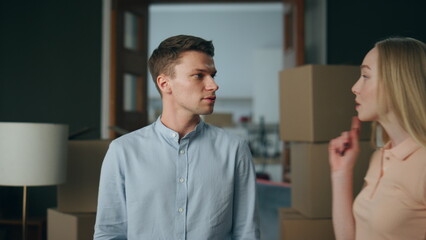 Fototapeta premium Conflicted wife swearing husband at home waving finger close up. Family arguing.
