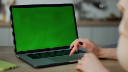 Woman using mockup laptop working remotely at home close up. Hands scrolling