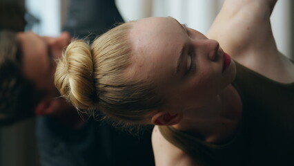 Yogi couple practicing pose inverted triangle training together at home close up