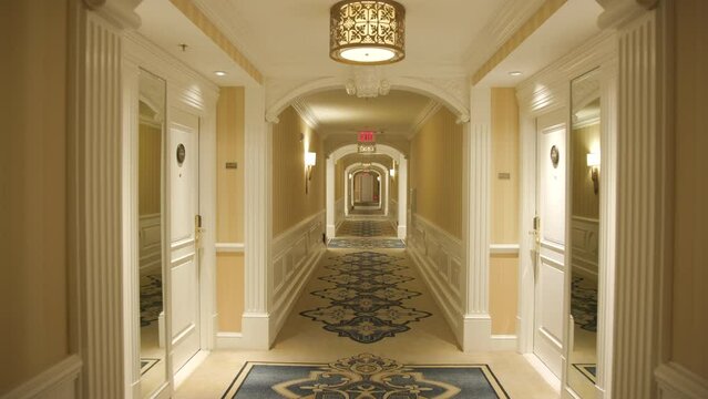 Luxury room corridor. Modern lobby interior. Point of view - walking through a hotel hallway. Empty Corridor in a hotel. Orange Pallet. High quality 4k footage