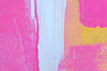 Messy paint strokes and smudges on an old painted wall. White, pink, yellow drips, flows, streaks...
