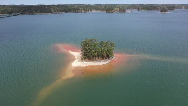 Drone Video of Small Wooded Island With Sandy Beaches in Lake Surrounded by Forest