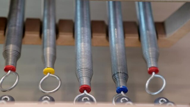 Pilates machine springs changing resistance force of sliding platform for comfortable training professional equipment for sports activities and exercises in gym closeup