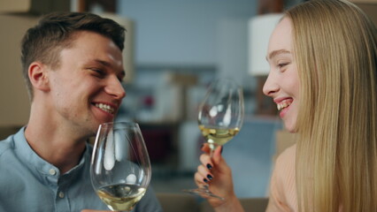 Family celebrating relocation drinking wine in glasses close up. Housewarming.