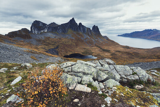 Looking from the very top of mount Hesten looking north towards a spectacular mountain range in full autumnal colors in Troms og Finnmark, Norway