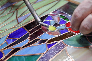 Stained glass window solder pieces of glass
