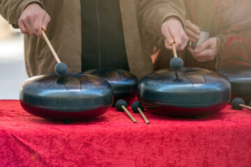 Steel tongue, drum. Singing bowl, steel drum and drumsticks. Instrument for sound wave therapy and...