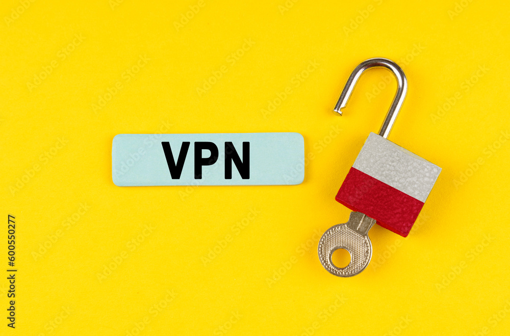 Poster on the yellow surface is an open lock with a key and a sticker with the inscription - vpn