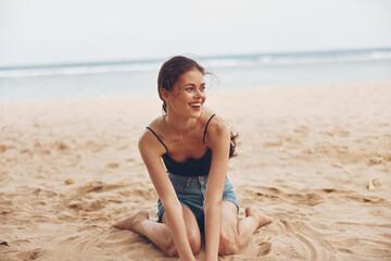 Fototapeta na wymiar woman smile beach sand sea model sitting travel vacation nature freedom
