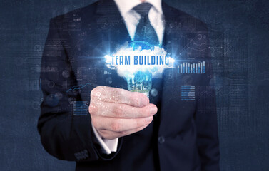 Businessman holding a light bulb, business concept