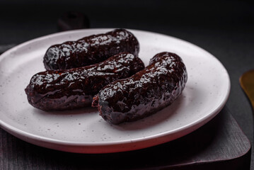 Delicious black blood sausage or black pudding with spices and herbs