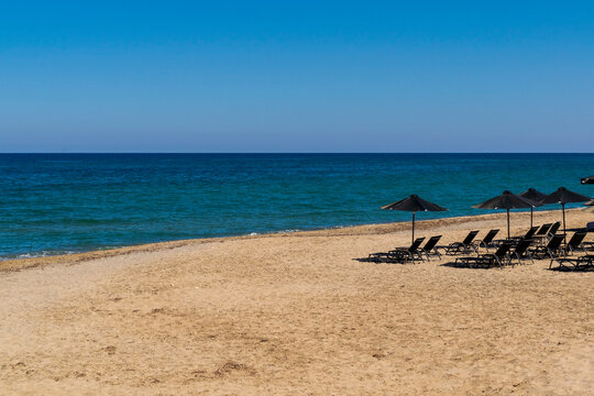 Beach on the mediterranean sea. Beach umbrellas and sunbeds.