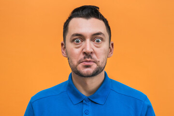Portrait of the man on orange background. Man's emotions