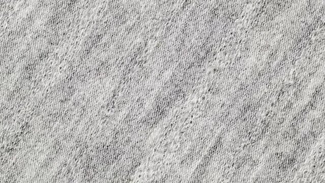 Sulfur grey fabric close-up, woven surface background wallpaper, rotating, turning, close-up, macro
