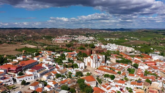 View of Silves town buildings with famous castle and cathedral, Algarve region, Portugal. Walls of medieval castle in Silves town, Algarve region, Portugal.