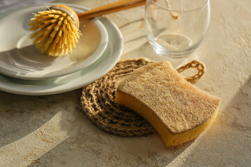 Natural household sponges and brush on color background, closeup