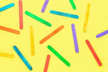 Colorful ice cream sticks on beige background