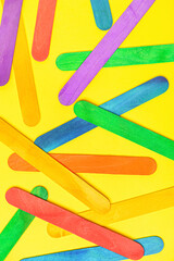 Colorful ice cream sticks on beige background