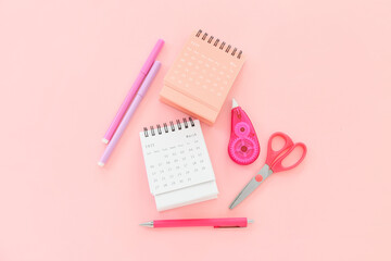 Flip paper calendars and stationery on pink background