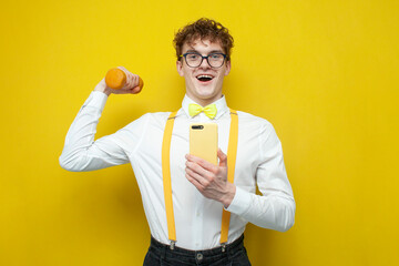 nerd student in shirt with bow tie and suspenders goes in for sports and uses smartphone, guy...