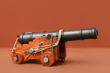 Toy model of cannon on brown background