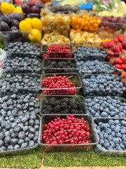 blueberries and berries on the counter in the market