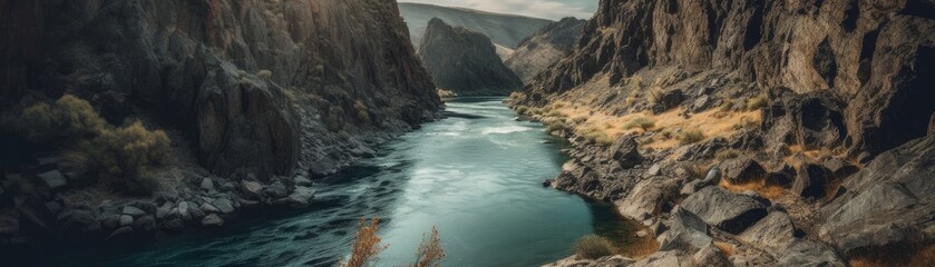 Fototapeta na wymiar A sparkling river winding through a rocky canyon. Horizontal banner. AI generated
