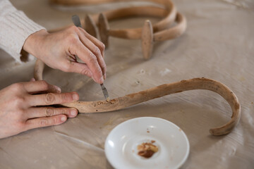 Restorer removes dirt from the cover of a wooden vintage item