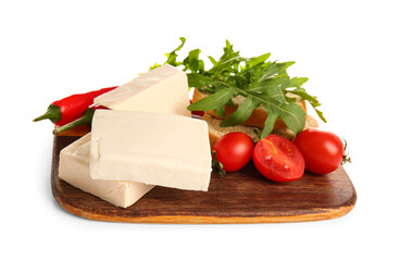 Board with processed cheese, bread and vegetables on white background