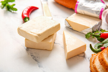 Processed cheese with bread and vegetables on grunge background